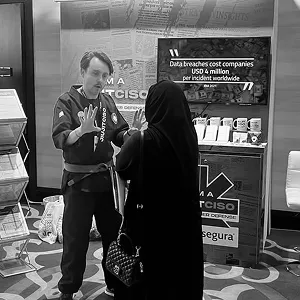 Man in a JiujitCISO gi greeting a visitor at the Segura™ booth