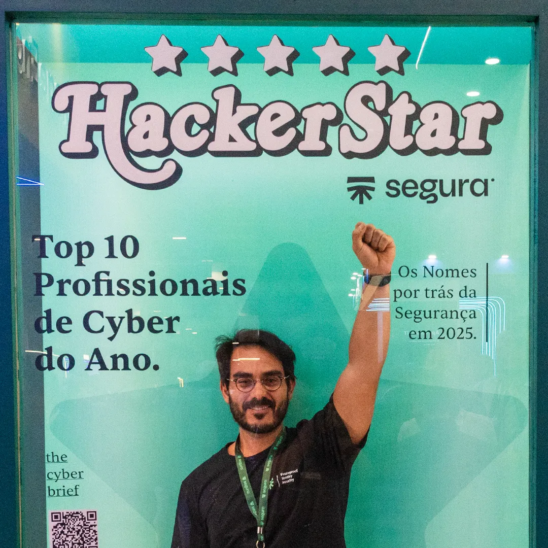 Man raising his fist in front of the Segura™ HackerStar banner honouring the top 10 cyber professionals of 2025