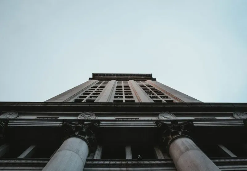Facade of a building with classical columns, seen from below