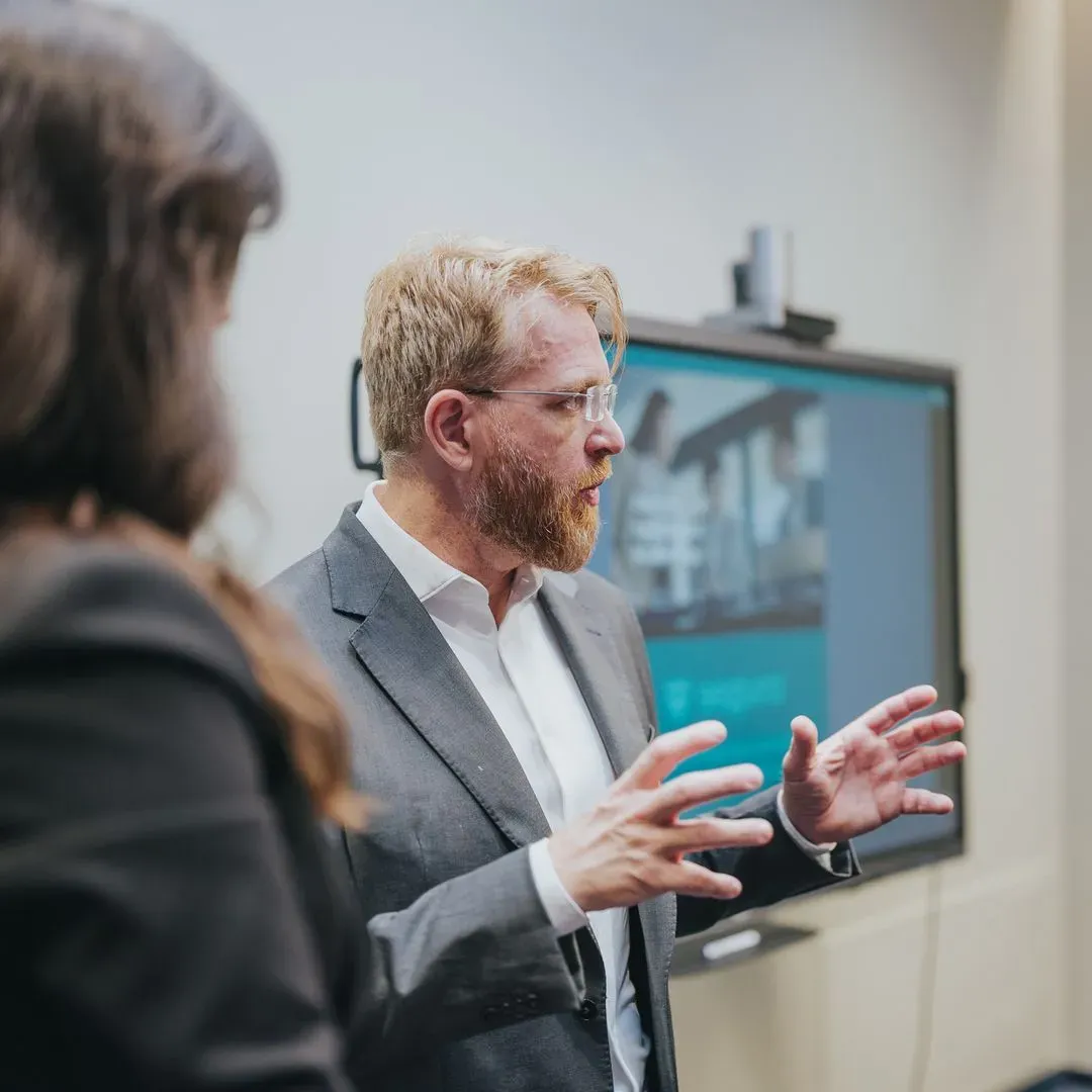 Segura™ executive giving a presentation in front of a screen at the Katowice Center of Excellence