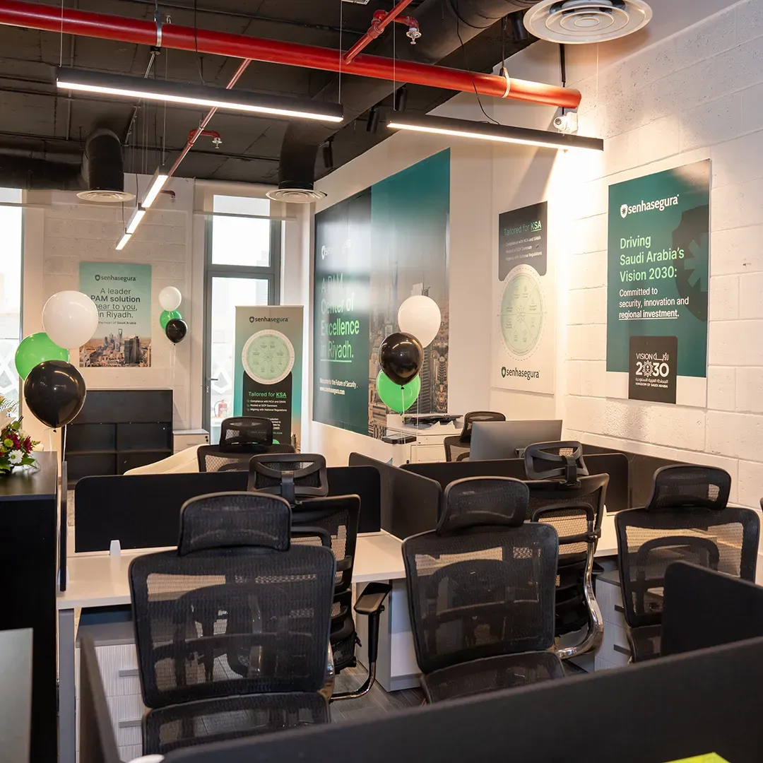 Riyadh Center of Excellence office with workstations and Vision 2030 posters